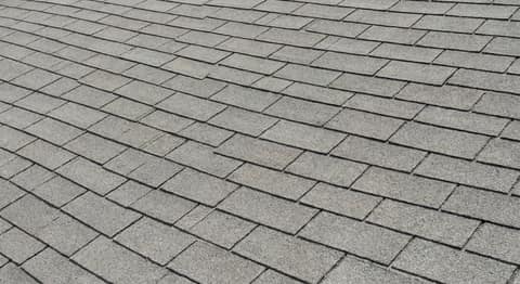 Close-up picture of 3-tab asphalt shingle roofing showing the texture and profile of the material