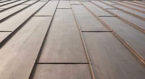 Close-up picture of copper roofing showing the texture and profile of the material