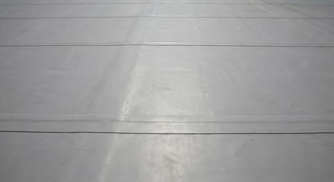 Close-up picture of tpo membrane roofing showing the texture and profile of the material