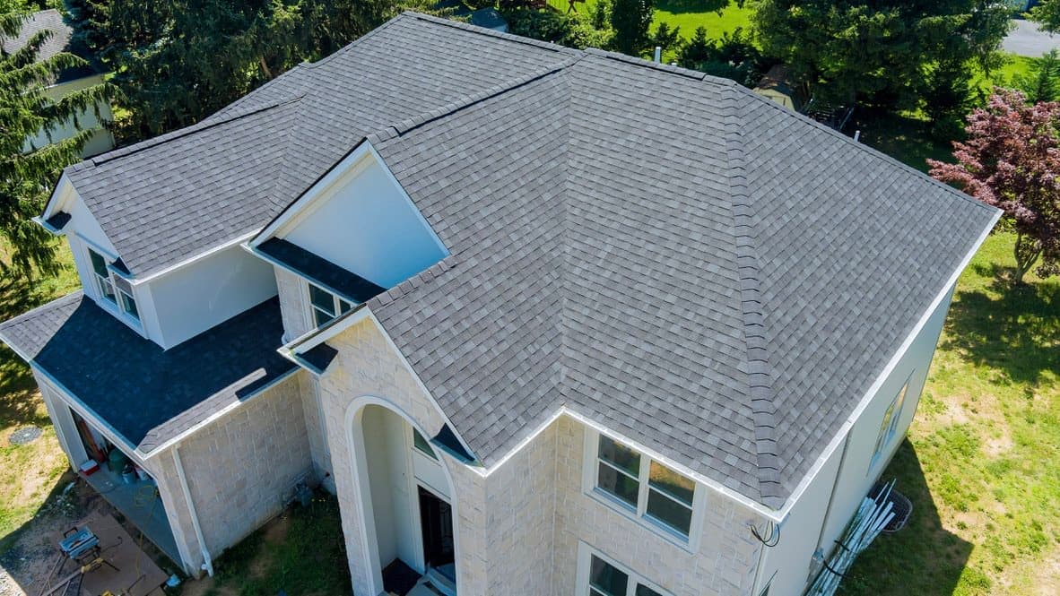 Before: Grey shingle to charcoal standing seam